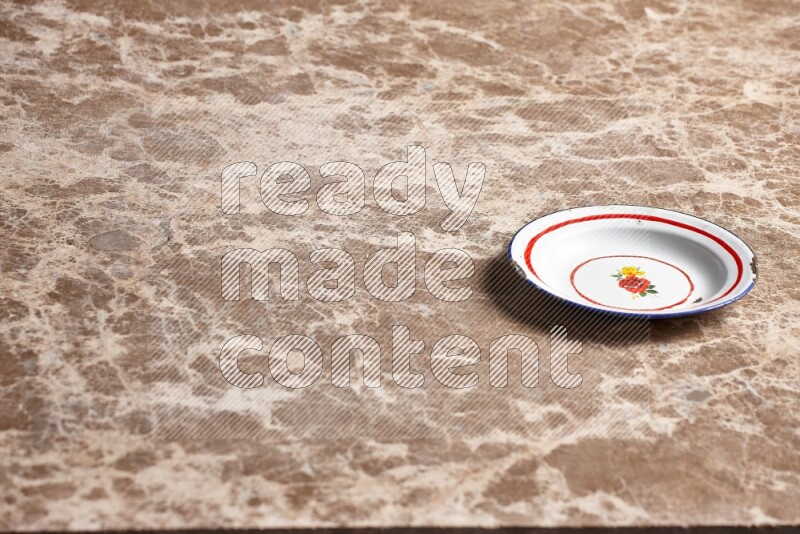 A vintage metal plate on beige marble background