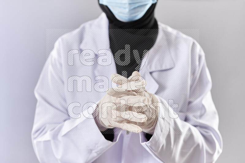 Female doctor wearing an abaya and medical attire in different positions