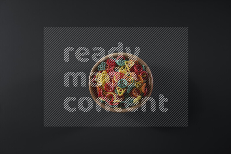 Snacks in a wooden bowl on grey background