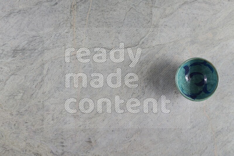 A multicolored pottery Bowl on grey marble background