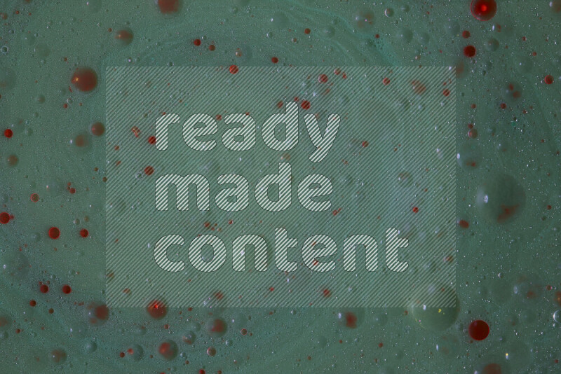 The image captures a dramatic splatter of red paint over a green backdrop