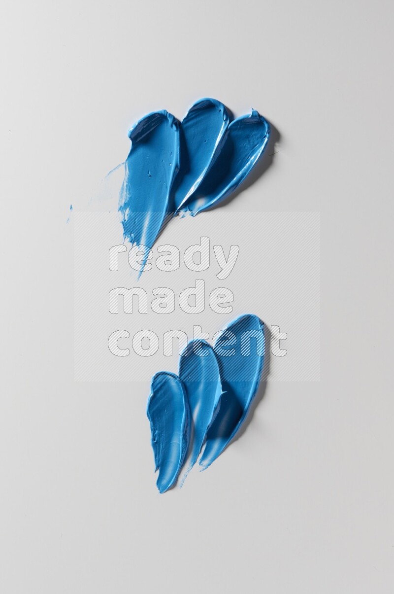 Blue painting knife strokes on white background