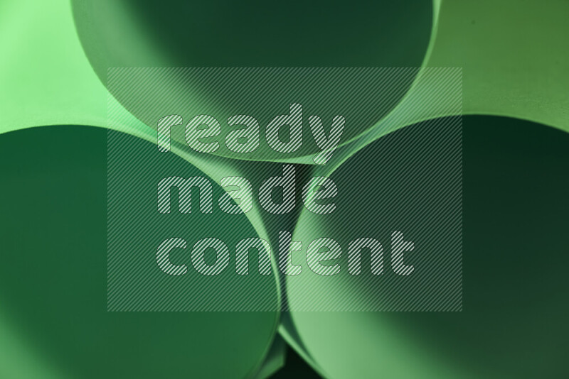 The image shows an abstract paper art with circular shapes in varying shades of green