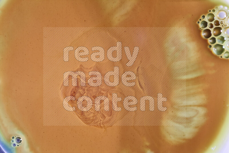 A close-up of abstract different swirling patterns in orange