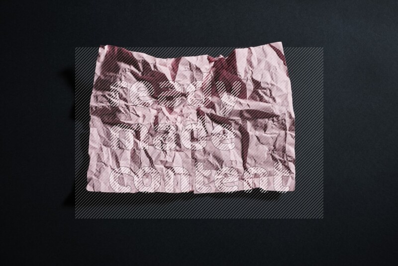 Pink paper sheet on black background