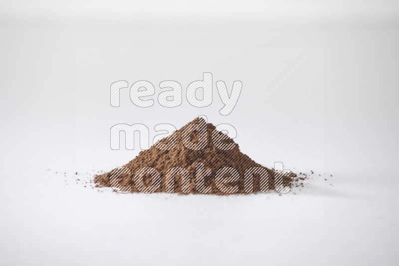 A pile of cloves powder on a white flooring