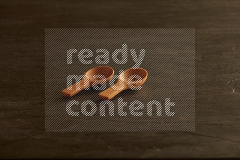 wooden spoon on black slate background