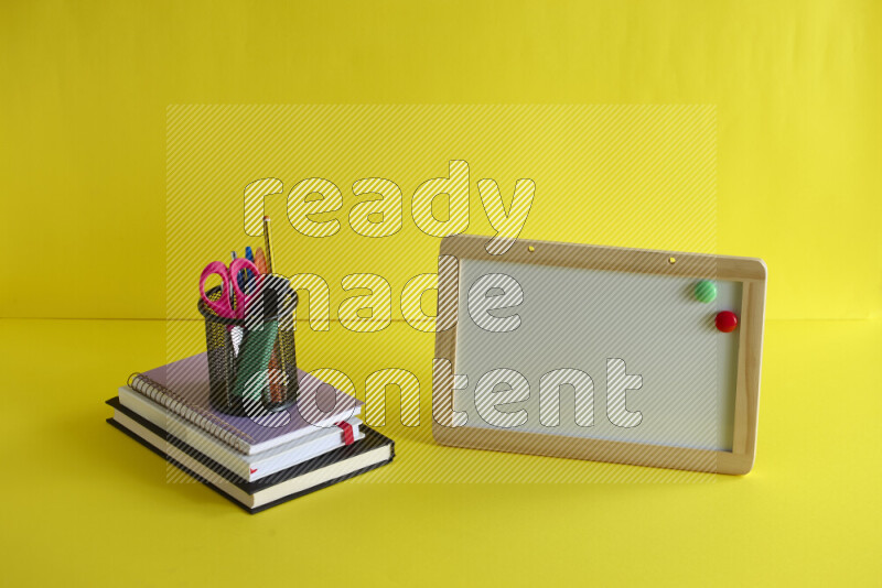 A whiteboard with different school supplies on yellow background