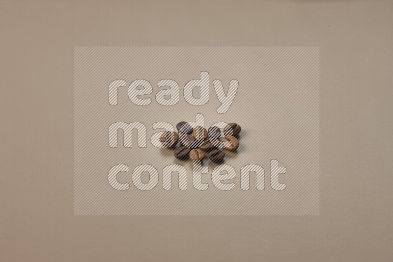 Roasted coffee beans on beige background