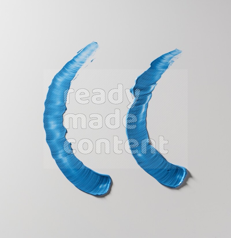 Blue curved painting knife strokes on white background