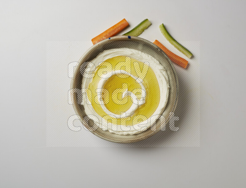 Lebnah garnished with olive oil in a grey pottery plate on a white background