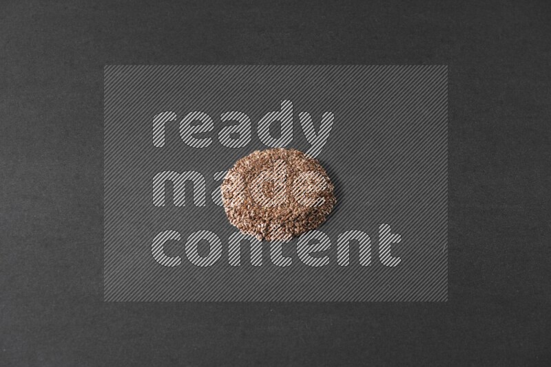 Flax Seeds in a circle shape on a black Flooring