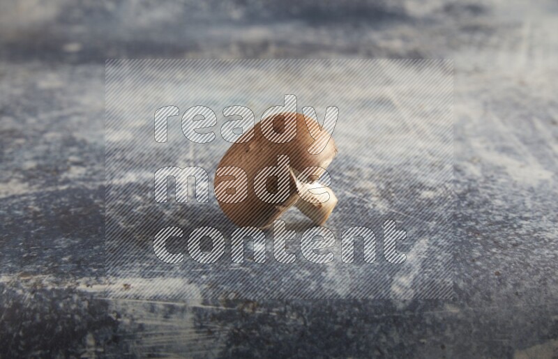 45 degre cremini  mushrooms on a textured rustic blue background