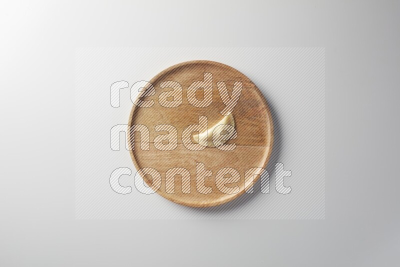 A single Sambosa on a wooden round plate on a white background