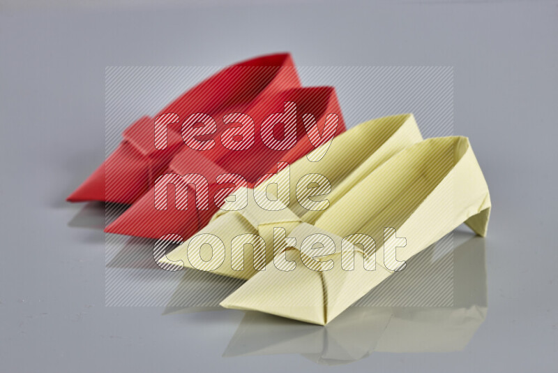 Origami shoes on grey background