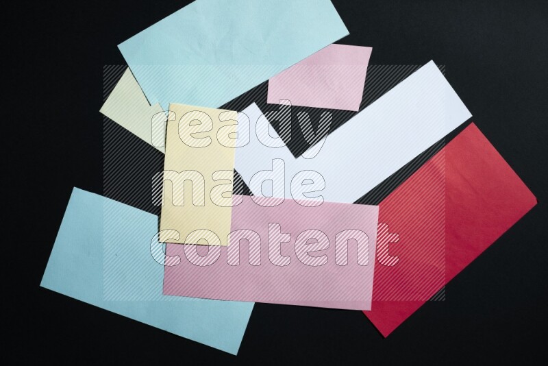 Multicolored paper sheet on black background