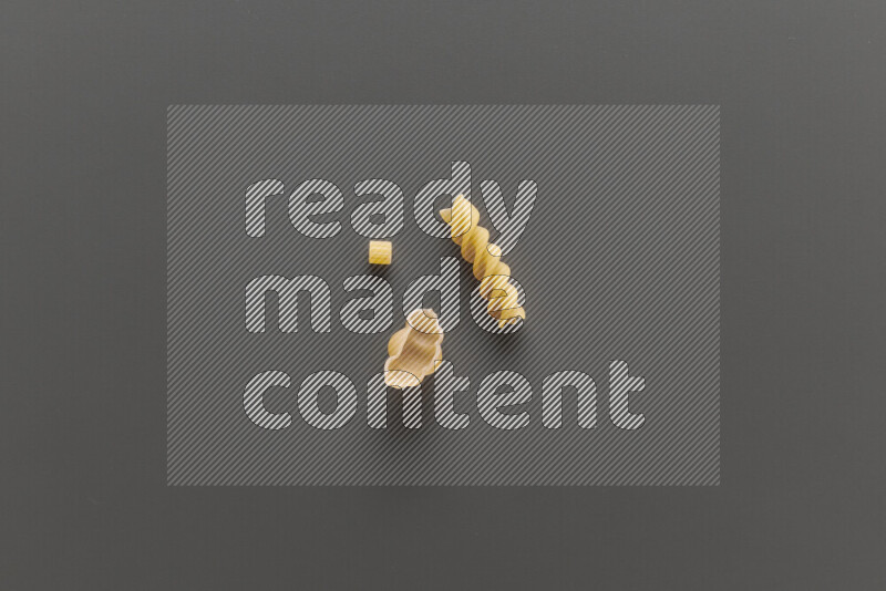 Different pasta types on grey background