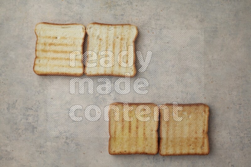 Toasted white Toast slices on a light blue textured background