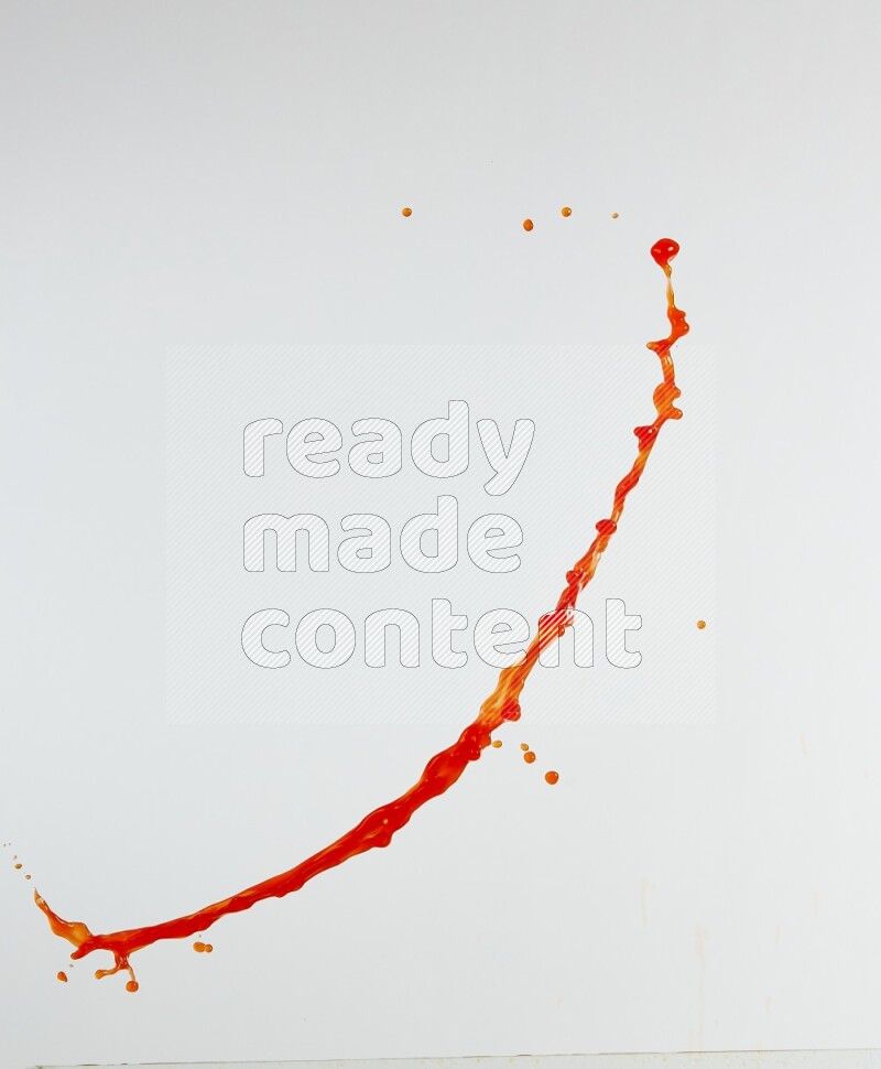Orange liquid splash and drops on white background