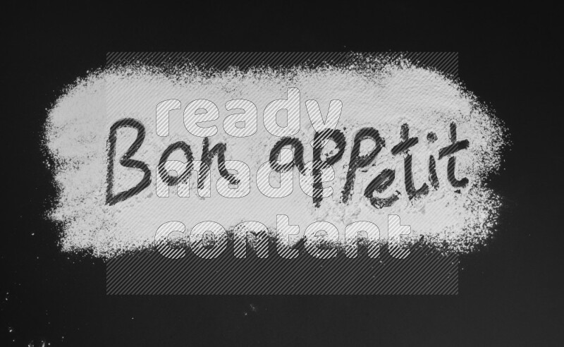 A sentence written with powder on black background