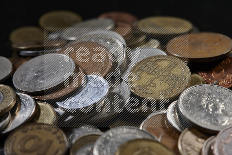A close-ups of random old coins on black background