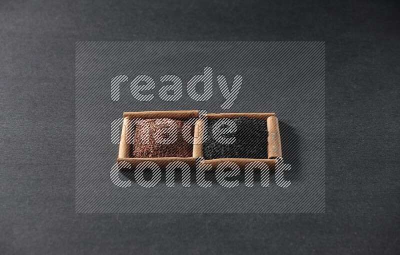 2 squares of cinnamon sticks full of garden cress and black seeds on black flooring