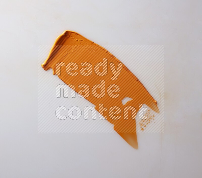 An orange straight painting knife stroke on white background