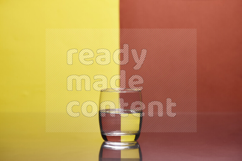 The image features a clear glassware filled with water, set against yellow and dark orange background