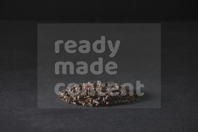 Cloves in a circle shape on a black flooring