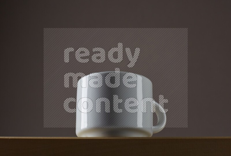 Low angle shot of a white cup on grey background
