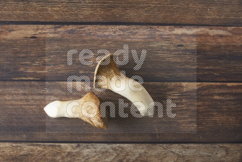 Fresh King oysters mushrooms topview on a wooden background