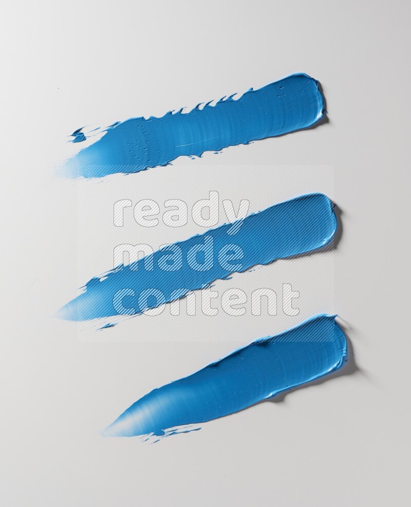 Blue painting knife strokes on white background