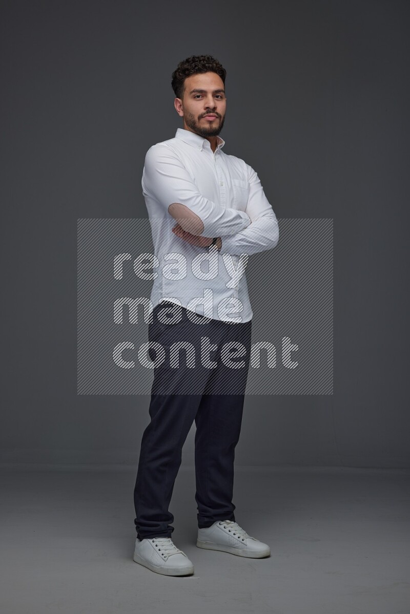 A man wearing smart casual making multi stand poses  eye level on a gray background