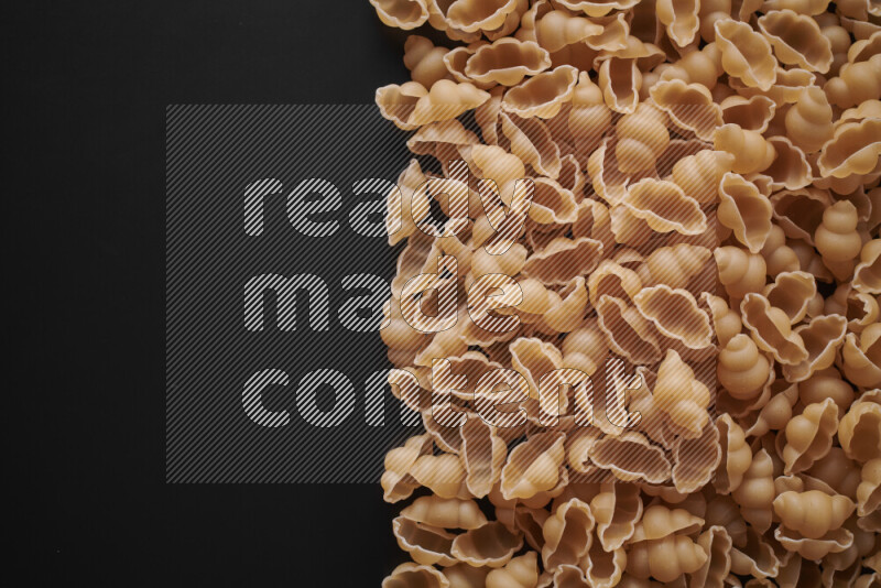 Different pasta types on black background