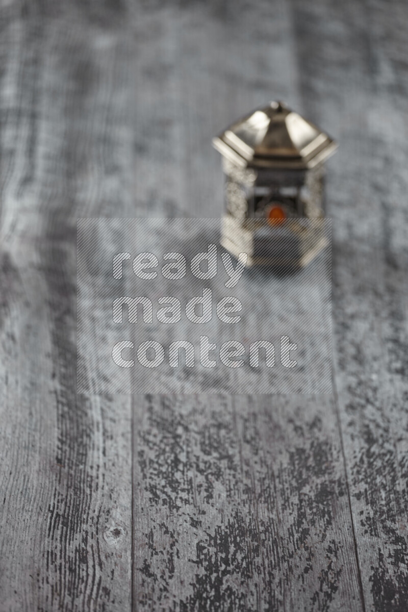 A lantern placed on a wooden background