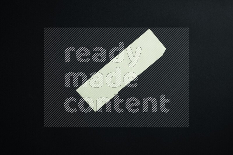 Green paper sheet on black background