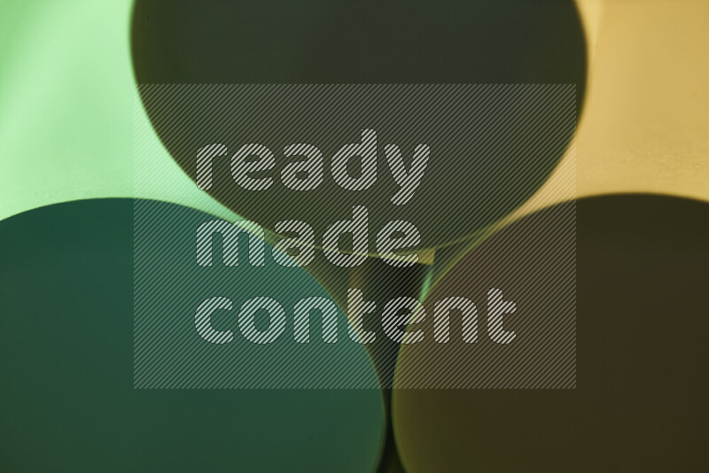 The image shows an abstract paper art with circular shapes in varying shades of green and warm tones