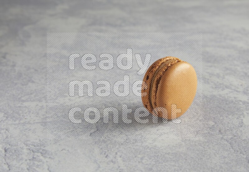 45º Shot of Brown Maple Taffy macaron on white  marble background