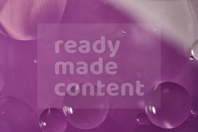 Close-ups of abstract oil bubbles on water surface in shades of white and purple