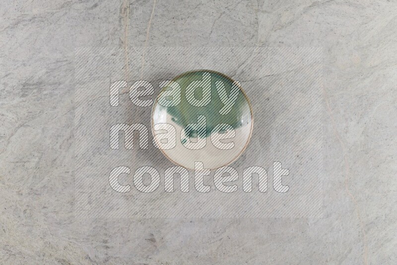 A multicolored pottery Bowl on grey marble background