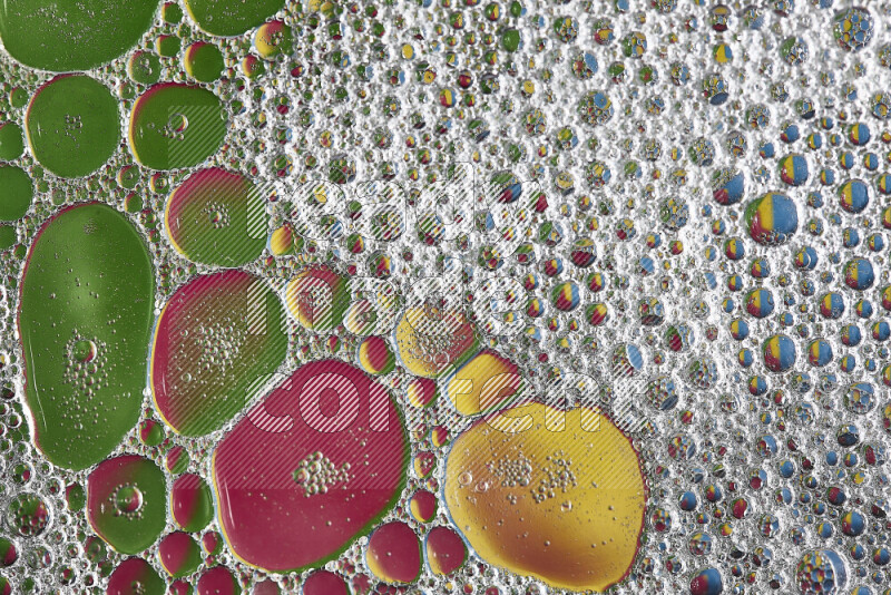 Close-ups of abstract soap bubbles and water droplets on multicolored background