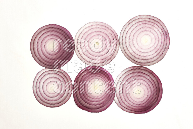 Onion slices on illuminated white background