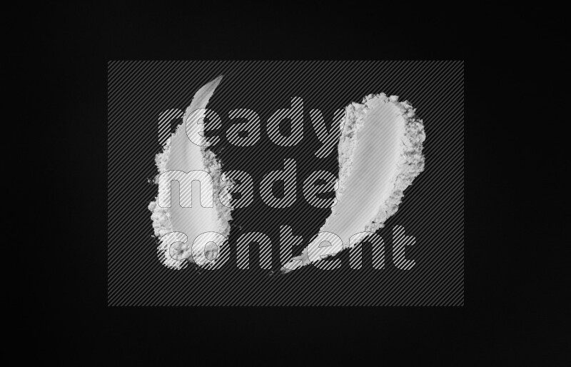 White powder smears on black background
