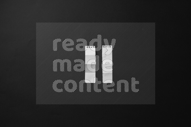 Ripped notebook sheet on black background