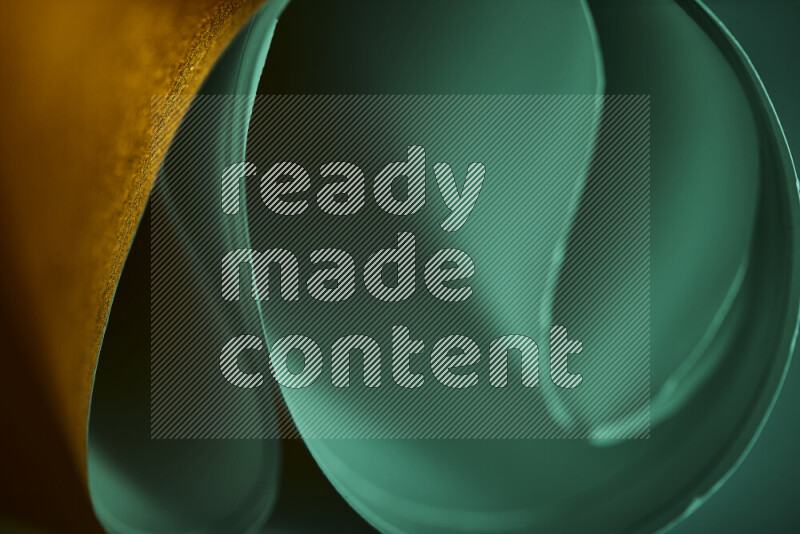 An abstract art piece displaying smooth curves in green and orange gradients created by colored light