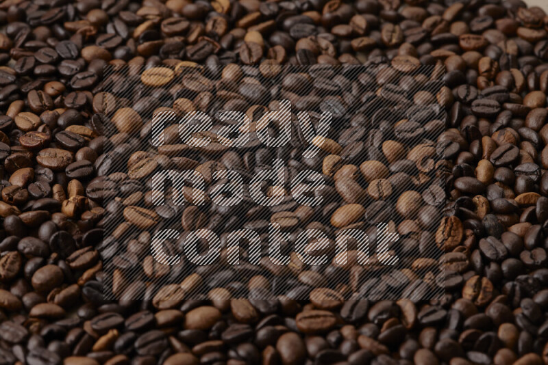 Roasted coffee beans on beige background