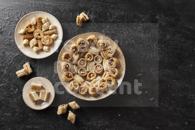 Oriental sweets in pottery plates in a dark setup
