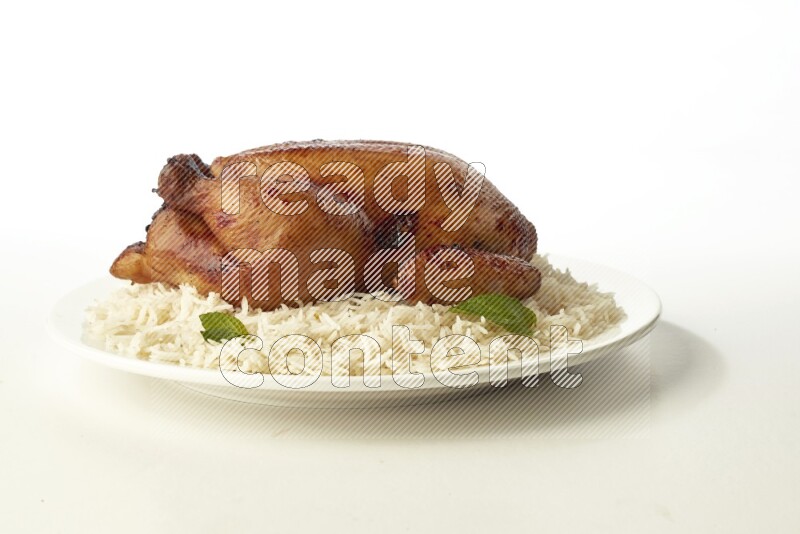 white  basmati Rice with  whole roasted chicken  on a white rounded plate direct on white background
