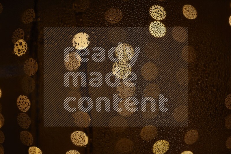 Bokeh light in yellow with water drops