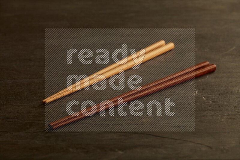 wooden chopsticks on black slate background